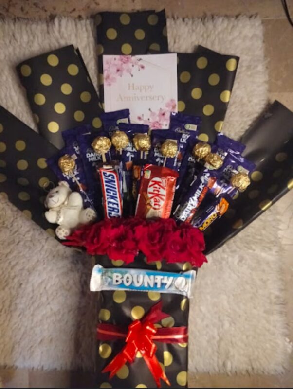 Product Description: Chocolate Bouquet in Karachi – The Sweetest Gift Looking for a show-stopping birthday gift in Karachi that combines luxury, sweetness, and wow factor? Our handmade chocolate bouquets are the perfect solution. More than just a box of chocolates, we create exquisite, fresh flower and chocolate bouquets that are a feast for the eyes and the palate. At Woodmsrt Giftshop, each chocolate bouquet is crafted with artistry. We use premium branded chocolates like Cadbury, Ferrero Rocher, Kinder, and Toblerone, intertwined with fresh roses, elegant baby's breath, lush eucalyptus, and decorative accents. The result is a unique gift in Karachi that is unforgettable. Why Our Chocolate Bouquets Are the Best Gift in Karachi: Handmade with Care: Every bouquet is custom-made to order, ensuring freshness and premium presentation. Wide Variety: Choose from Ferrero Rocher bouquets, Cadbury chocolate bouquets, Kinder bouquet designs, or mixed chocolate bouquets. For Every Occasion: While a perfect birthday chocolate bouquet, they are also ideal as: Eid gifts and Eid chocolate bouquets Anniversary gifts and romantic gifts for her Congratulations gifts for graduations & promotions Get well soon gifts and thank you gifts Valentine's Day gifts and Mother’s Day gifts Themes & Personalization: Select from elegant red rose bouquets, pastel theme bouquets, balloon bouquet combos, or teddy bear chocolate bouquets. Add a personalized gift card for a special touch. Fast & Reliable Delivery: We offer same-day chocolate bouquet delivery in Karachi to DHA, Clifton, Gulshan, Bahadurabad, Nazimabad, and all surrounding areas. Perfect For: Surprising a wife, girlfriend, mother, sister, or best friend. It’s a unique gift idea for her that never fails to impress. Also a great corporate gift or client gift. Order your stunning chocolate bouquet online today and deliver a smile! Keywords: chocolate bouquet, chocolate bouquet Karachi, chocolate bouquet delivery in Karachi, Ferrero Rocher bouquet, Cadbury chocolate bouquet, handmade chocolate bouquet, chocolate and flower bouquet, birthday chocolate bouquet, chocolate bouquet for birthday, Eid chocolate bouquet, chocolate bouquet for Eid, anniversary chocolate bouquet, chocolate bouquet for her, chocolate bouquet for girlfriend, chocolate bouquet for wife, romantic chocolate gift, premium chocolate bouquet, luxury chocolate bouquet, unique chocolate bouquet, fresh flower chocolate bouquet, rose and chocolate bouquet, Kinder surprise bouquet, customized chocolate bouquet, chocolate bouquet with teddy bear, chocolate bouquet with balloons, gift bouquet Karachi, online chocolate bouquet, same day delivery chocolate bouquet, best chocolate bouquet in Karachi, affordable chocolate bouquet, chocolate bouquet price in Karachi, chocolate bouquet ideas, chocolate bouquet for men, chocolate bouquet for him, thank you chocolate bouquet, get well soon chocolate bouquet, congratulations chocolate bouquet, graduation chocolate bouquet, Valentine's Day chocolate bouquet, Mother's Day chocolate bouquet, women's day chocolate bouquet, DIY chocolate bouquet, chocolate gift ideas, flower bouquet with chocolates, chocolate arrangement, chocolate basket, chocolate hamper, sweet bouquet, candy bouquet, premium gift delivery Karachi, gifts for chocolate lovers, unique gifts in Karachi, last minute gift idea, surprise gift delivery, gourmet chocolate bouquet, branded chocolate bouquet, Toblerone bouquet, Milka chocolate bouquet, Snickers bouquet, chocolate bouquet for baby shower, bridal shower chocolate bouquet, corporate chocolate gift, office gift, client appreciation gift, chocolate bouquet Karachi DHA, Clifton chocolate delivery, Gulshan chocolate bouquet, send chocolate bouquet online, order chocolate bouquet, chocolate bouquet design, large chocolate bouquet, small chocolate bouquet, mini chocolate bouquet, chocolate rose bouquet, white chocolate bouquet, dark chocolate bouquet, chocolate bouquet delivery today, midnight delivery chocolate bouquet, chocolate bouquet with greetings card, personalized chocolate gift.